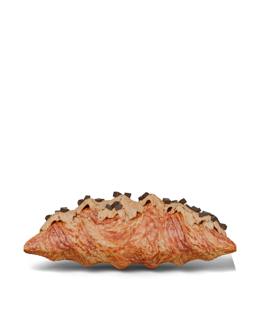 A flaky Cookie Croissant topped with chocolate-chip cookie and icing sugar.